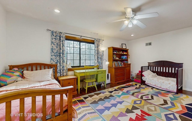 bedroom with ceiling fan and dark wood-type flooring