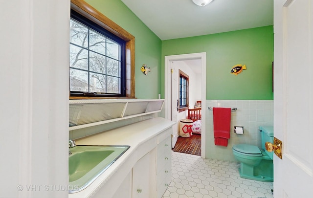 bathroom featuring toilet, vanity, and tile patterned floors