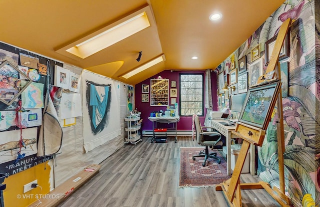 home office featuring wood-type flooring, a baseboard heating unit, and lofted ceiling