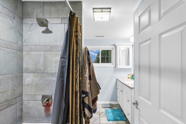 bathroom featuring tile patterned flooring, a shower with curtain, and vanity