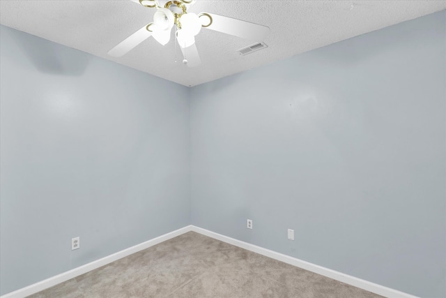 carpeted empty room with a textured ceiling and ceiling fan