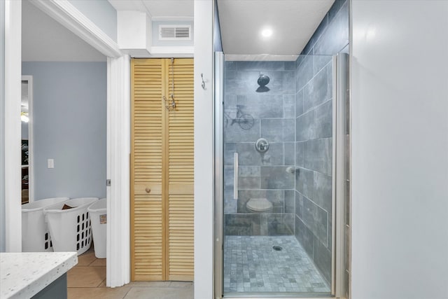 bathroom with tile patterned floors, vanity, and an enclosed shower