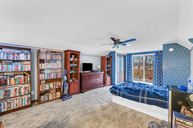 bedroom featuring carpet flooring, a textured ceiling, vaulted ceiling, and ceiling fan