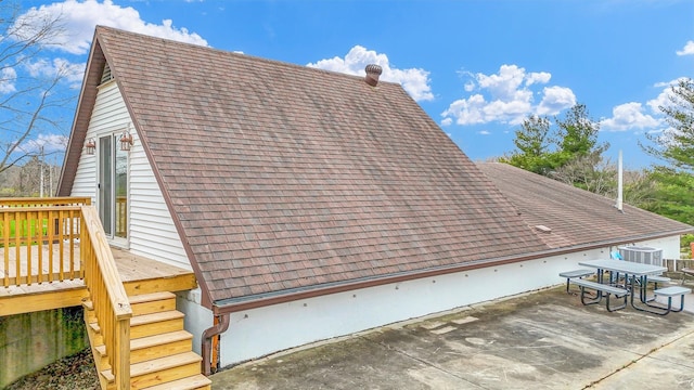 view of property exterior featuring a patio area and a wooden deck