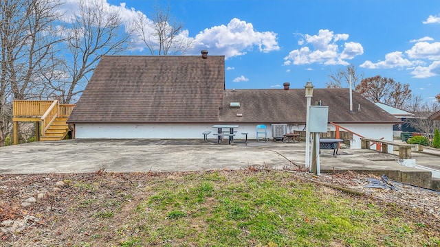 back of property featuring a patio area and a wooden deck