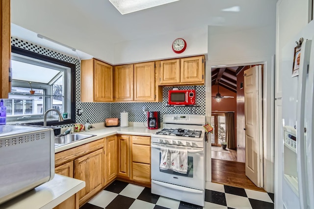 kitchen with decorative backsplash, gas range gas stove, and sink