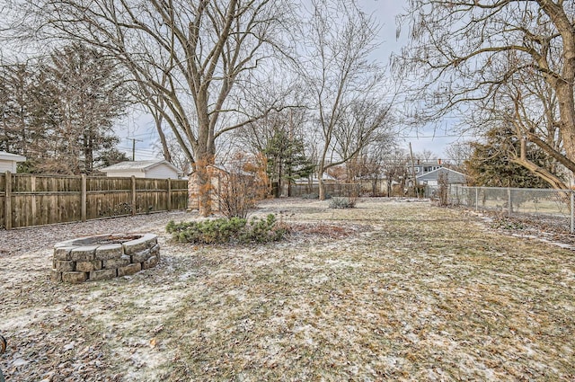 view of yard with an outdoor fire pit