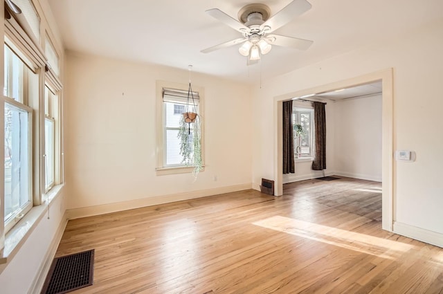 empty room featuring light wood-type flooring and ceiling fan