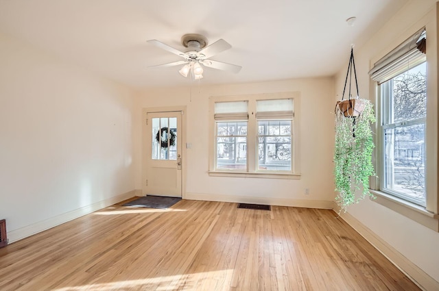 doorway to outside with ceiling fan, light hardwood / wood-style flooring, and plenty of natural light