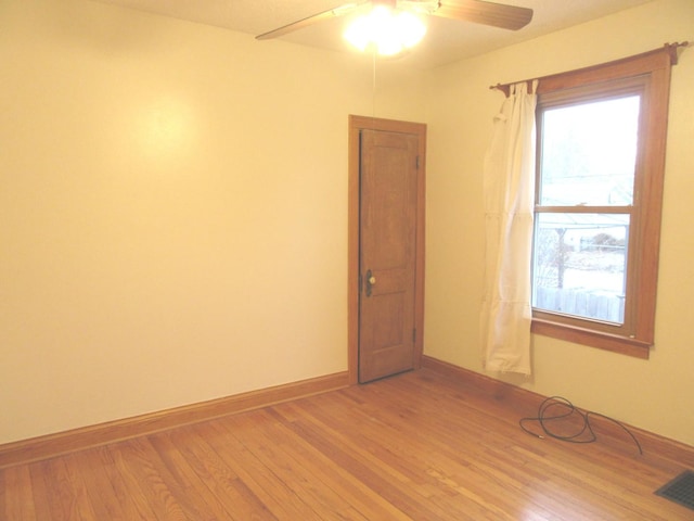 unfurnished room with light wood-type flooring and ceiling fan