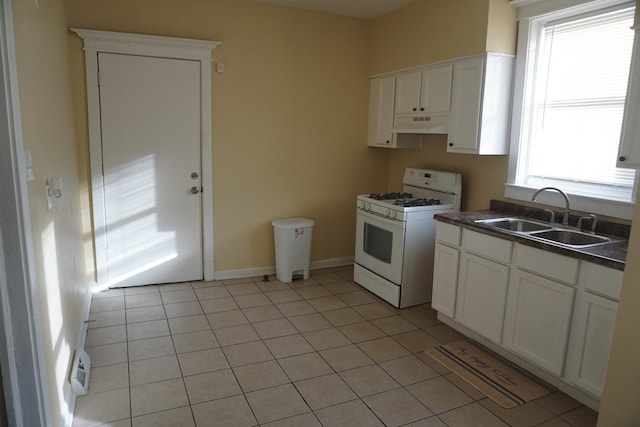 kitchen with white cabinets, a healthy amount of sunlight, sink, and white range with gas cooktop