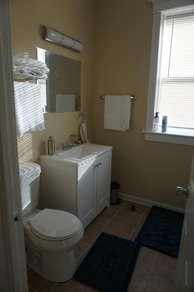 bathroom featuring tile patterned flooring, vanity, and toilet