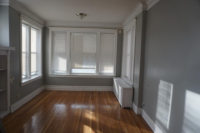 unfurnished room with dark hardwood / wood-style floors, crown molding, and a healthy amount of sunlight