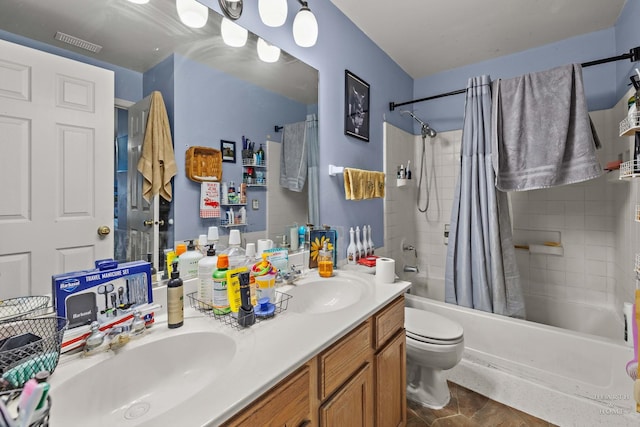 full bathroom with tile patterned floors, shower / bath combination with curtain, toilet, and vanity