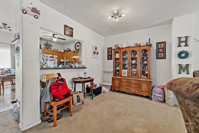 interior space featuring light carpet and ceiling fan