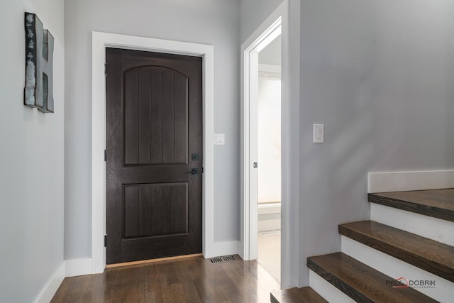 entryway with dark hardwood / wood-style flooring