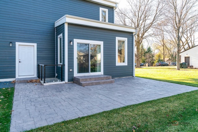 back of property featuring a yard and a patio area