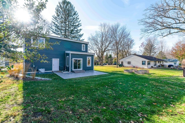 rear view of house featuring a yard and a patio