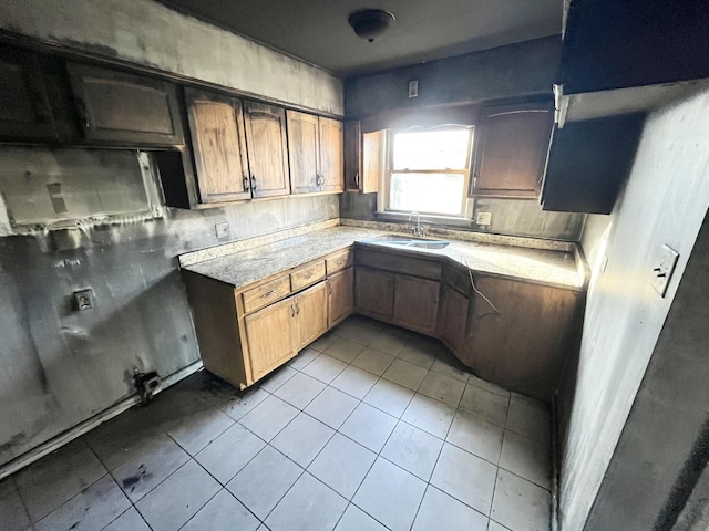 kitchen with light tile patterned floors and sink