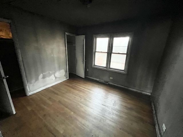 unfurnished bedroom with dark hardwood / wood-style flooring