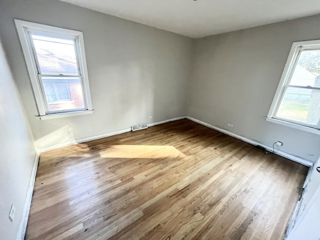 spare room featuring light hardwood / wood-style floors