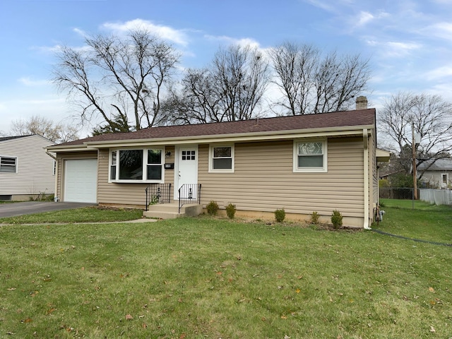 view of front of property featuring a garage and a front yard