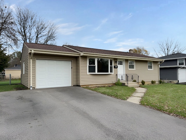 single story home featuring a garage and a front lawn