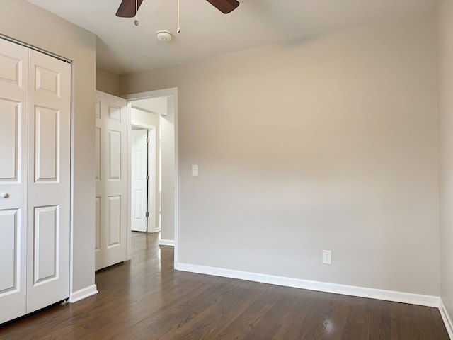 interior space featuring ceiling fan, a closet, and dark wood-type flooring