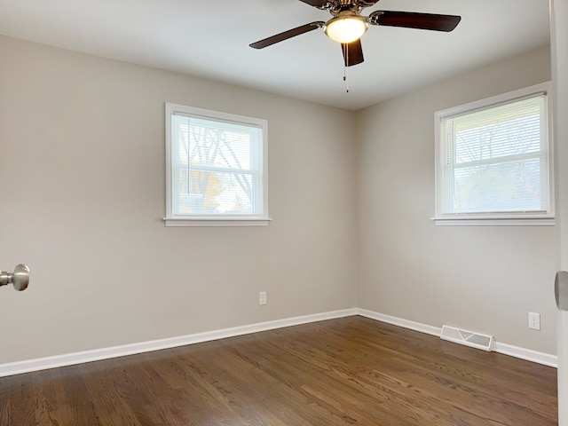 unfurnished room featuring ceiling fan and dark wood-type flooring