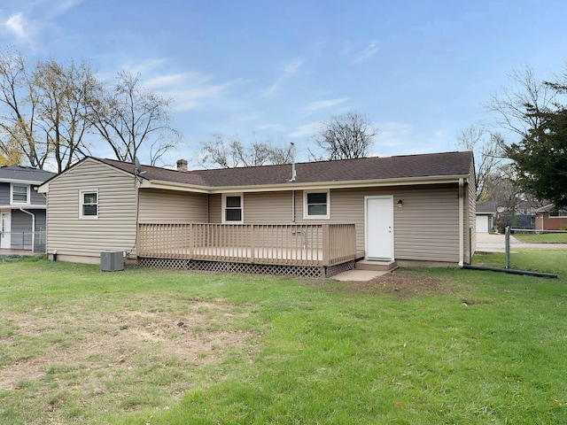 back of house featuring a lawn, a deck, and central air condition unit