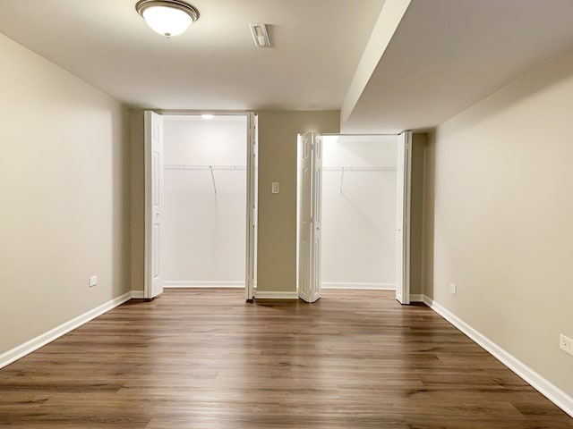 unfurnished bedroom with dark hardwood / wood-style floors