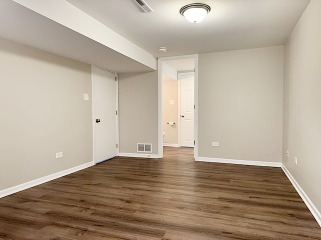 unfurnished room featuring dark wood-type flooring