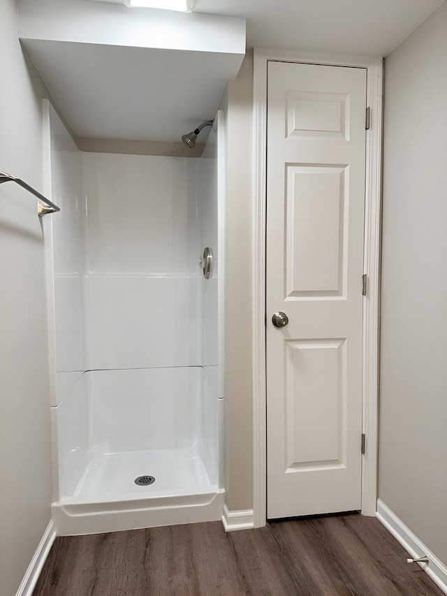 bathroom with hardwood / wood-style floors and walk in shower