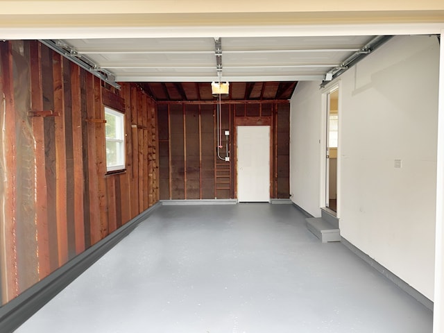 garage with wood walls and a garage door opener