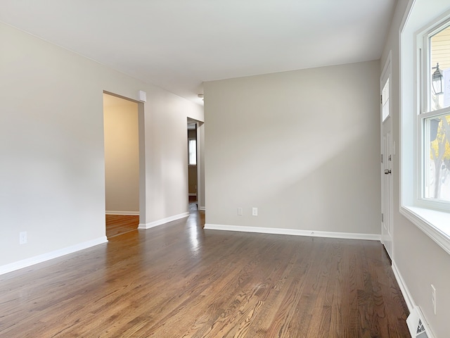 spare room with dark hardwood / wood-style floors