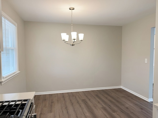 unfurnished dining area with an inviting chandelier and dark wood-type flooring