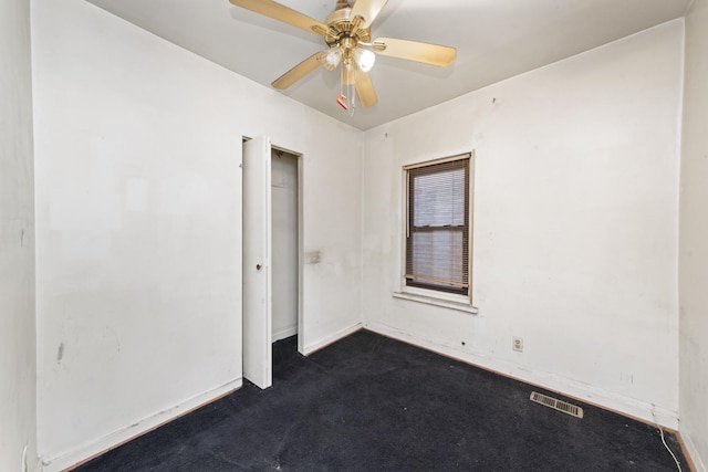 carpeted spare room featuring ceiling fan