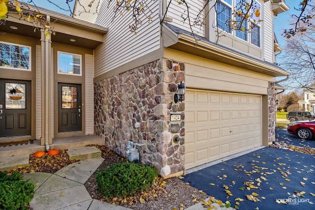 doorway to property featuring a garage