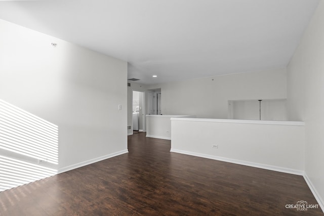 empty room with dark wood-type flooring