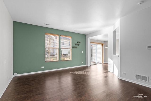 unfurnished living room with dark hardwood / wood-style flooring