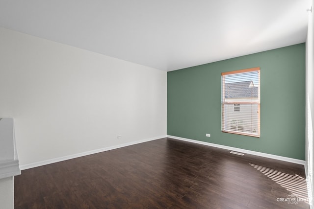 spare room featuring dark hardwood / wood-style floors