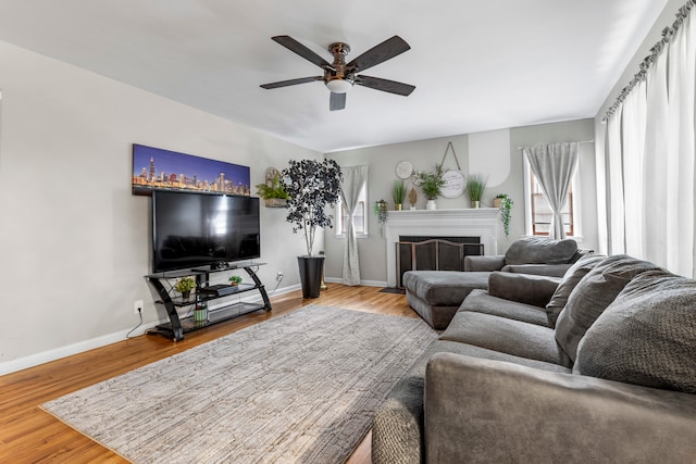 living room featuring hardwood / wood-style flooring and ceiling fan