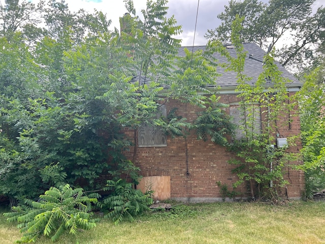 view of home's exterior with a yard