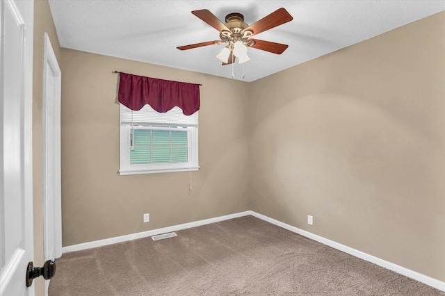 spare room featuring ceiling fan, carpet floors, and a textured ceiling