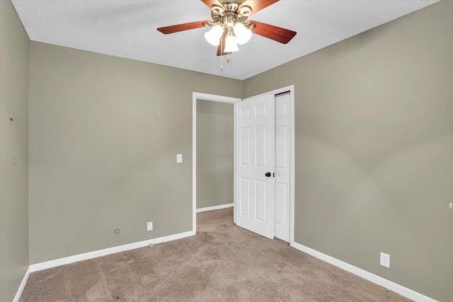 unfurnished bedroom with ceiling fan and light colored carpet