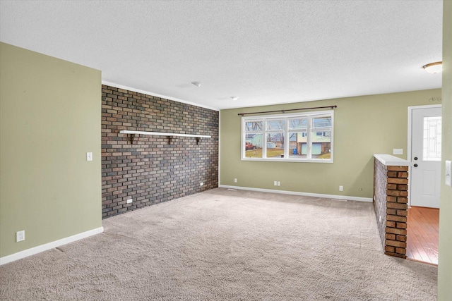 unfurnished living room featuring carpet floors and a textured ceiling