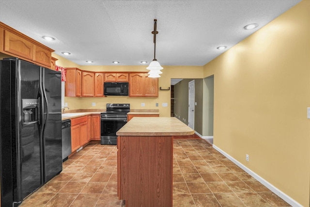 kitchen with black appliances, sink, hanging light fixtures, a textured ceiling, and a kitchen island