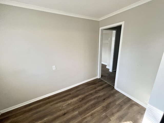 unfurnished room featuring dark hardwood / wood-style flooring and ornamental molding