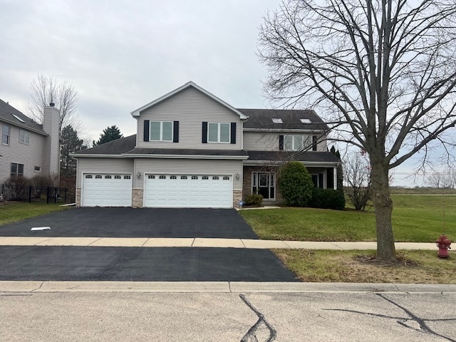 view of front of home featuring a garage and a front yard