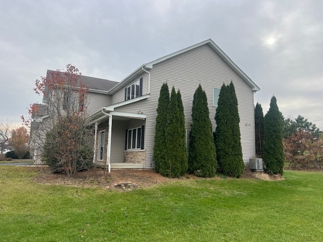 view of property exterior featuring a lawn and central AC unit